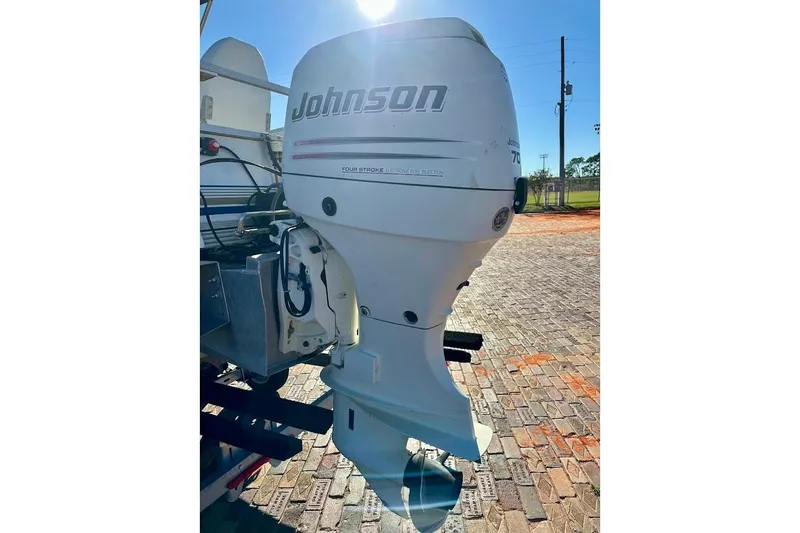 Slide: The Image of 2004 Crest 2200 Family DL with Johnson outboard motor on brick pavement. - 10