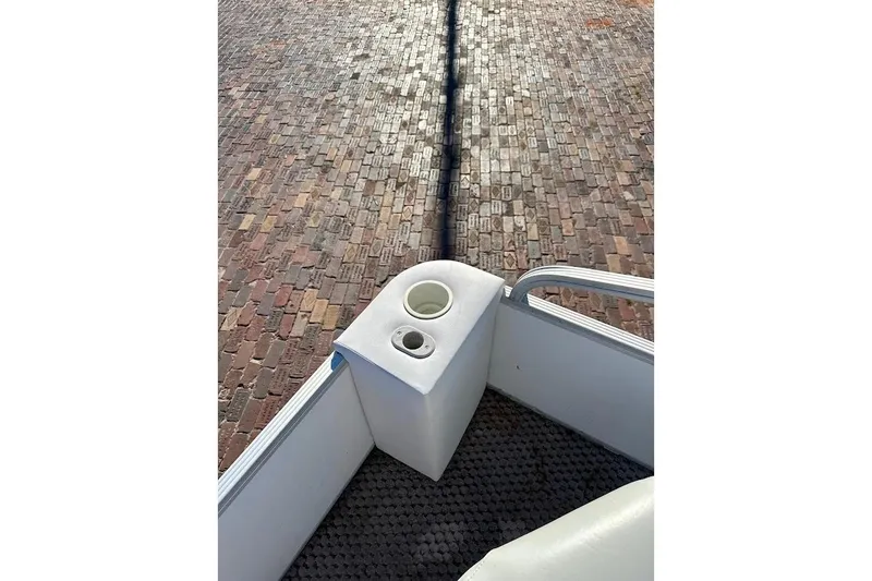 Slide: The Image of 2004 Crest 2200 Family DL boat corner with cup holders on brick pavement. - 14