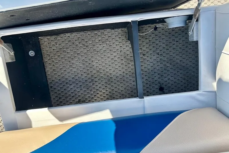 Slide: The Image of Open storage compartment in 2004 Crest 2200 Family DL boat with textured flooring. - 17