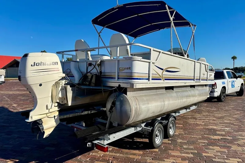 Slide: The Image of 2004 Crest 2200 Family DL pontoon boat on trailer with Johnson outboard motor. - 2