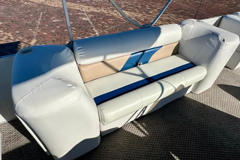Slide: The Image of 2004 Crest 2200 Family DL boat seating with beige and blue upholstery. - 21