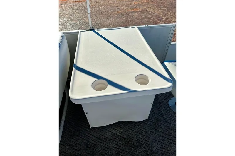 Slide: The Image of 2004 Crest 2200 Family DL boat table with cup holders, secured with blue strap. - 24