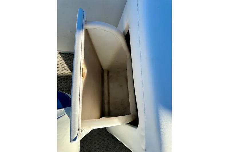 Slide: The Image of Open storage compartment in 2004 Crest 2200 Family DL boat. - 31