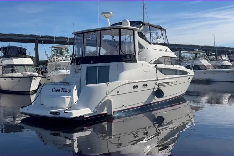 Slide: The Image of 2004 Meridian 459 Motoryacht docked, calm water, blue sky. - 2