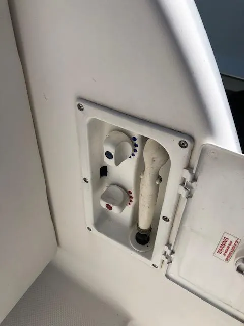 Slide: The Image of Control panel on a 2004 Meridian 459 Motoryacht, featuring knobs and a hose. - 22