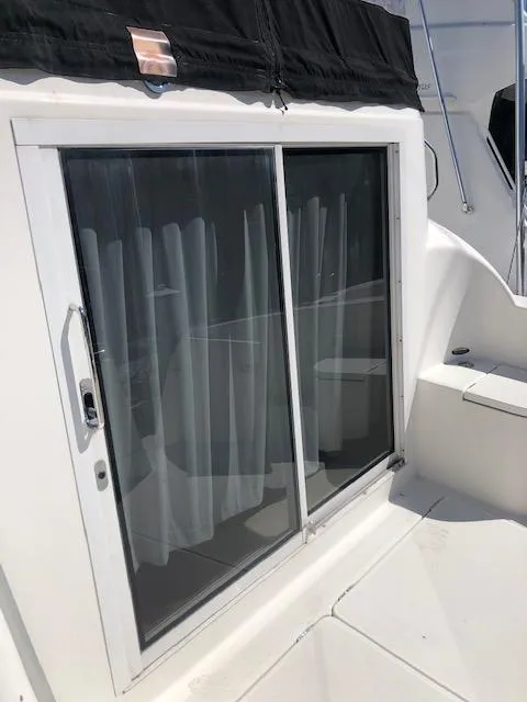 Slide: The Image of 2004 Meridian 459 Motoryacht sliding glass door with curtains. - 27