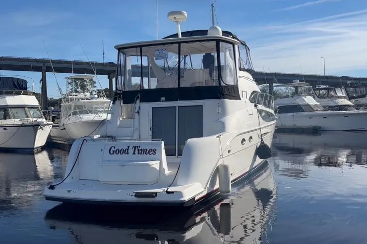 Slide: The Image of 2004 Meridian 459 Motoryacht docked, calm water, blue sky. - 3