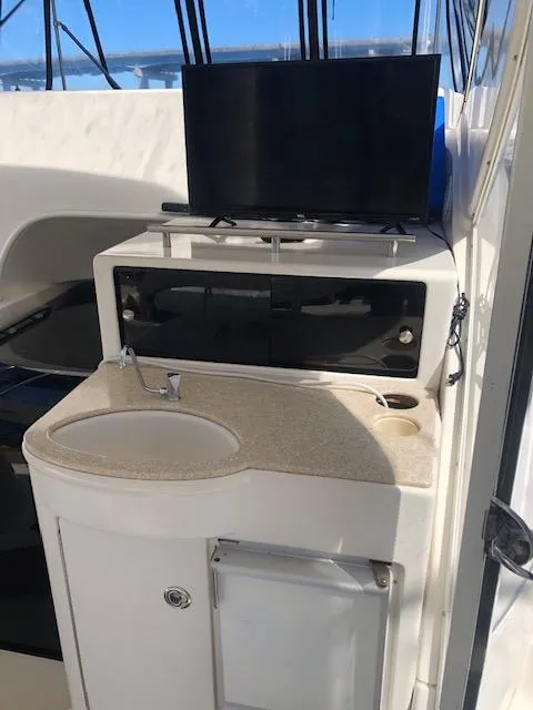 Slide: The Image of 2004 Meridian 459 Motoryacht interior with sink and TV setup. - 31