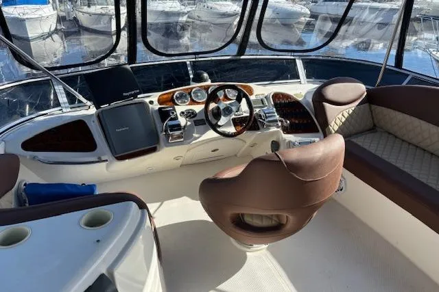 Slide: The Image of 2004 Meridian 459 Motoryacht helm with leather seating and modern navigation equipment. - 6