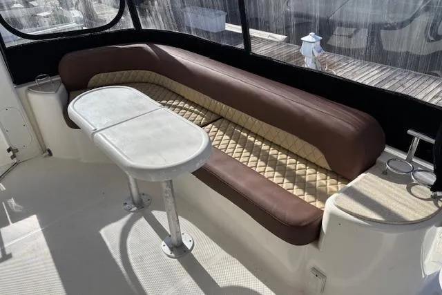 Slide: The Image of Luxurious seating area on 2004 Meridian 459 Motoryacht with elegant table and cushions. - 9