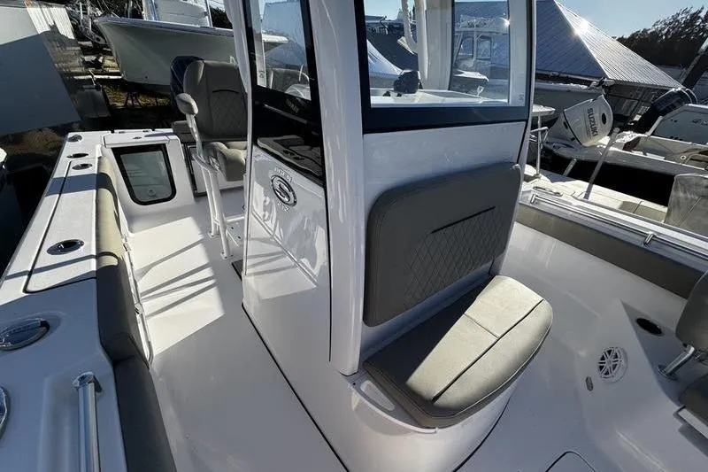Slide: The Image of 2026 Sportsman Open 212 Center Console boat interior with seating and console view. - 10