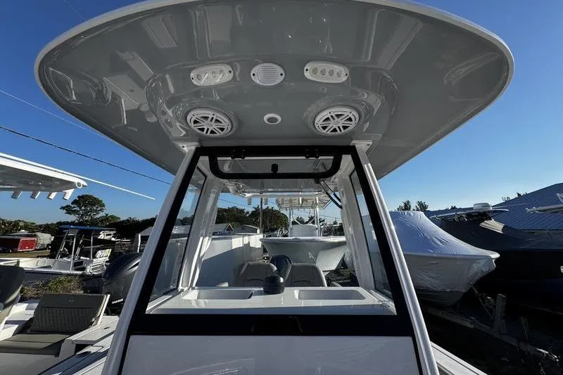 Slide: The Image of 2026 Sportsman Open 212 Center Console boat with modern T-top and speakers. - 11