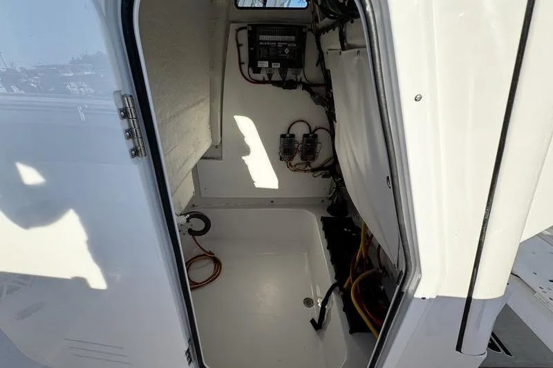 Slide: The Image of 2026 Sportsman Open 212 Center Console interior with wiring and storage space. - 13