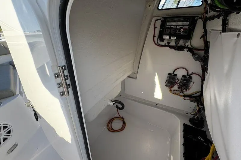 Slide: The Image of 2026 Sportsman Open 212 Center Console interior wiring and storage compartment. - 14
