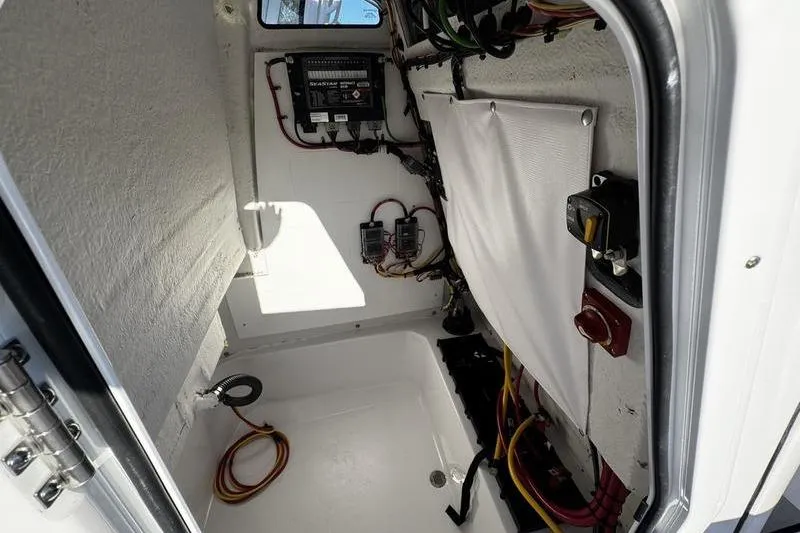 Slide: The Image of Interior view of 2026 Sportsman Open 212 Center Console boat wiring compartment. - 15