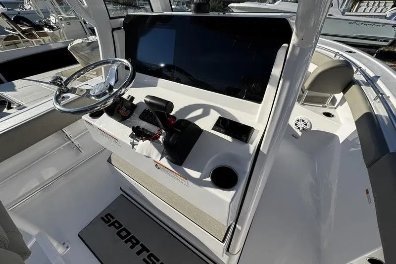Slide: The Image of 2026 Sportsman Open 212 Center Console boat interior with steering wheel and controls. - 19