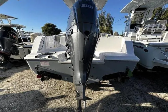 Slide: The Image of 2026 Sportsman Open 212 Center Console boat with powerful outboard motor, docked outdoors. - 25