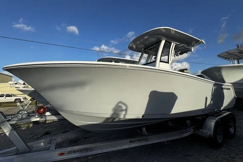 Slide: The Image of 2026 Sportsman Open 212 Center Console boat on trailer under blue sky. - 3