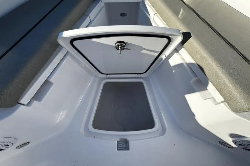 Slide: The Image of 2026 Sportsman Open 212 Center Console storage compartment with open hatch. - 8