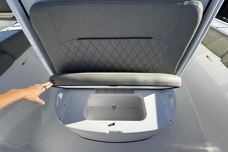Slide: The Image of 2026 Sportsman Open 212 Center Console seat with storage compartment open. - 9