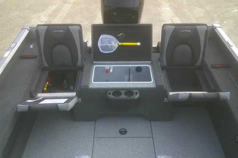 Slide: The Image of 2026 Lund 1875 Impact XS SS boat interior with storage compartments and seating. - 10