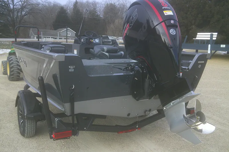 Slide: The Image of 2026 Lund 1875 Impact XS SS boat with powerful outboard motor on trailer. - 11