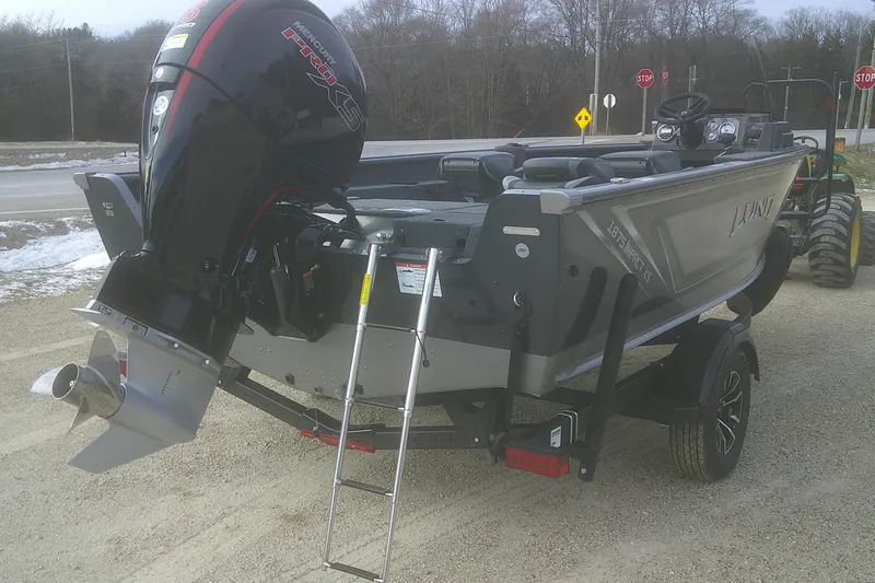Slide: The Image of 2026 Lund 1875 Impact XS SS boat with Mercury Pro XS engine on trailer. - 12