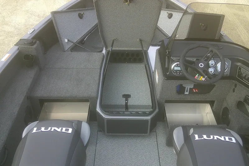 Slide: The Image of 2026 Lund 1875 Impact XS SS boat interior with storage compartments and steering console. - 5