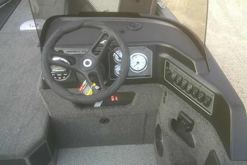 Slide: The Image of 2026 Lund 1875 Impact XS SS boat dashboard with steering wheel and control panel. - 6