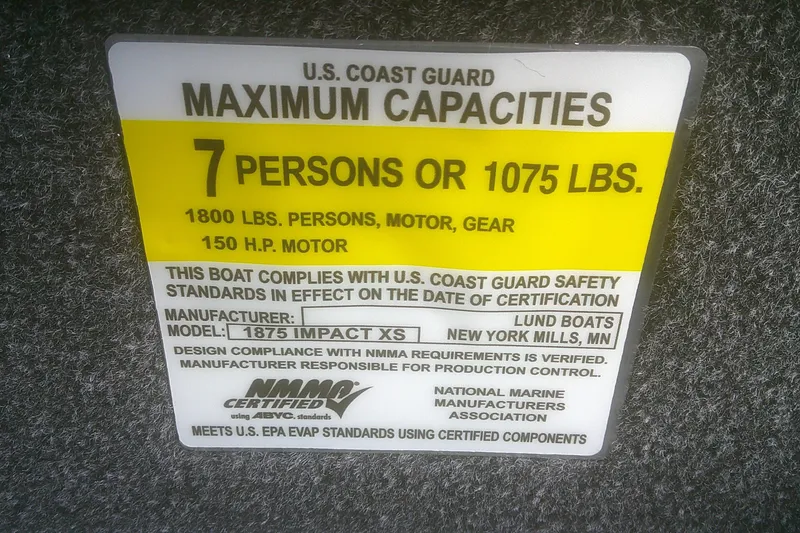 Slide: The Image of 2026 Lund 1875 Impact XS SS boat capacity label, 7 persons or 1075 lbs, USCG certified. - 7