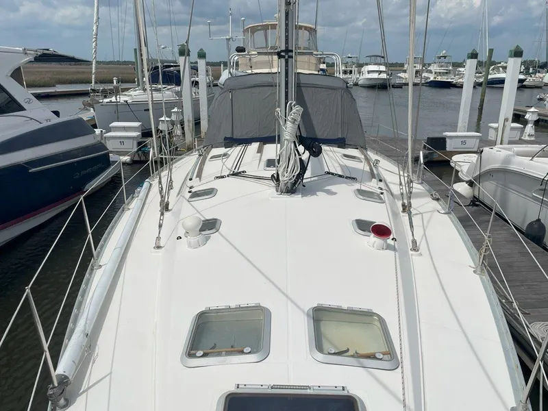 Slide: The Image of Jeanneau Sun Odyssey 45.2 sailboat docked at marina, 1998 model, white deck, clear sky. - 12
