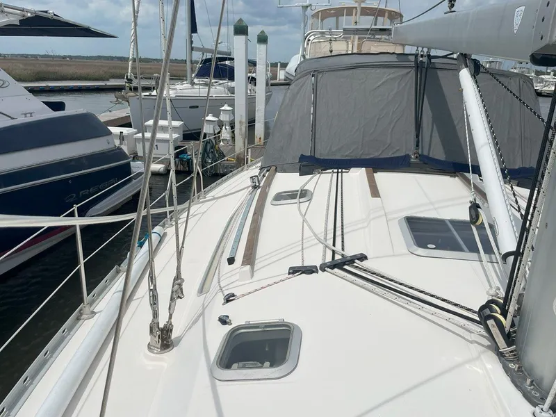 Slide: The Image of Jeanneau Sun Odyssey 45.2 sailboat docked, showcasing deck and rigging, 1998 model. - 13