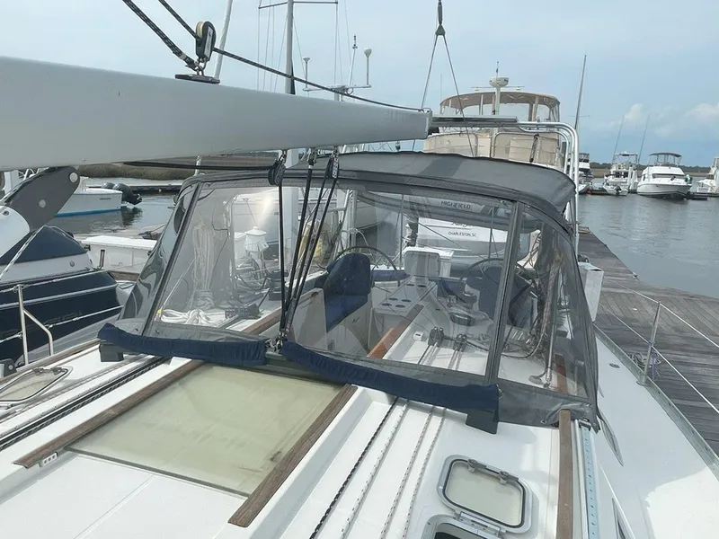 Slide: The Image of 1998 Jeanneau Sun Odyssey 45.2 sailboat docked at marina, featuring cockpit enclosure. - 15