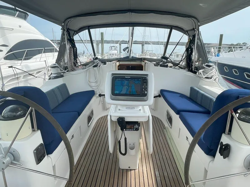 Slide: The Image of Cockpit of 1998 Jeanneau Sun Odyssey 45.2 sailboat with navigation equipment and blue seating. - 17