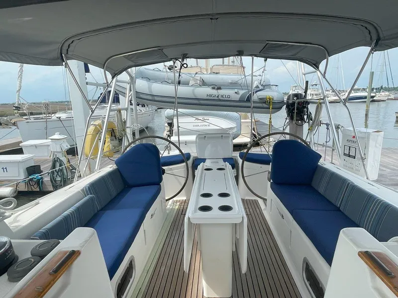 Slide: The Image of Cockpit of 1998 Jeanneau Sun Odyssey 45.2 sailboat with blue seating and dual steering wheels. - 18