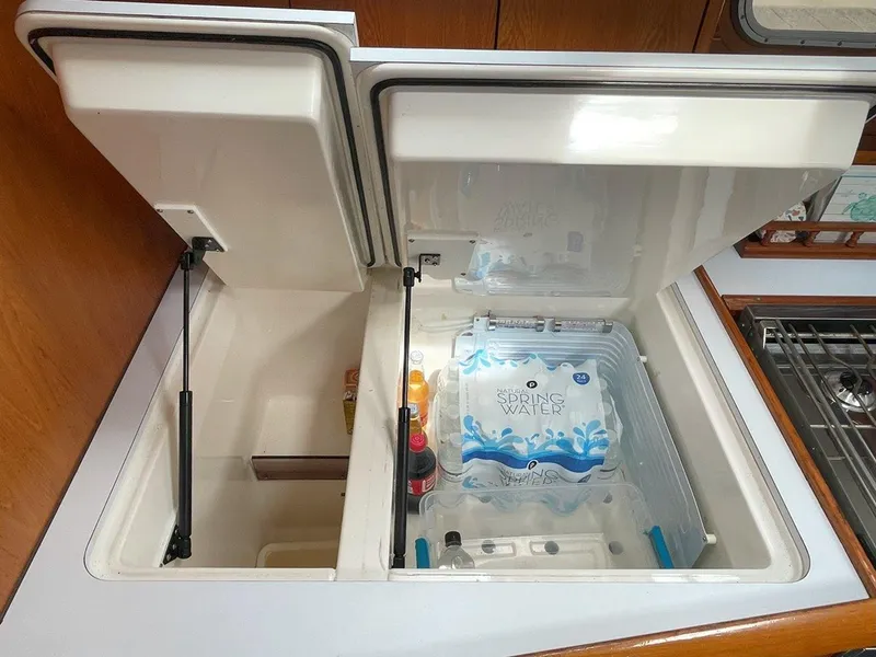 Slide: The Image of Interior view of Jeanneau Sun Odyssey 45.2 yacht's kitchen storage, featuring open compartments. - 32