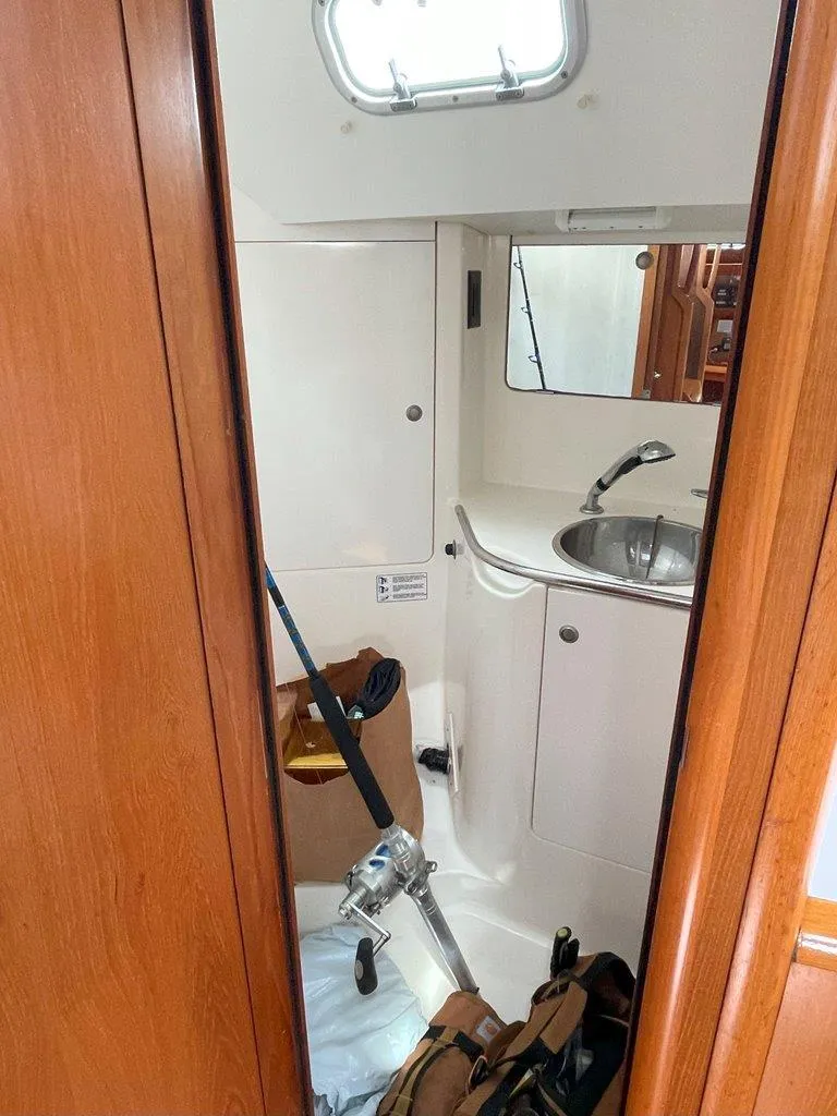 Slide: The Image of Interior view of 1998 Jeanneau Sun Odyssey 45.2 yacht bathroom with sink and fishing gear. - 39