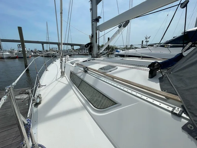 Slide: The Image of Jeanneau Sun Odyssey 45.2 sailboat docked, showcasing sleek deck design, 1998 model. - 6