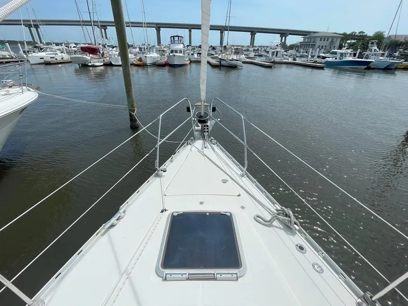 Slide: The Image of Bow view of 1998 Jeanneau Sun Odyssey 45.2 sailboat docked in a marina. - 8
