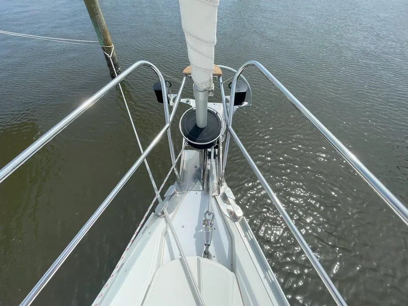 Slide: The Image of Bow of 1998 Jeanneau Sun Odyssey 45.2 sailboat on calm water. - 9