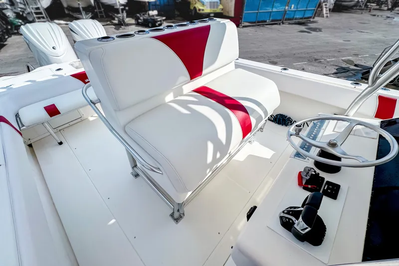 Slide: The Image of 2004 SeaVee 340i Cuddy boat interior with white and red seating, steering wheel, and controls. - 10