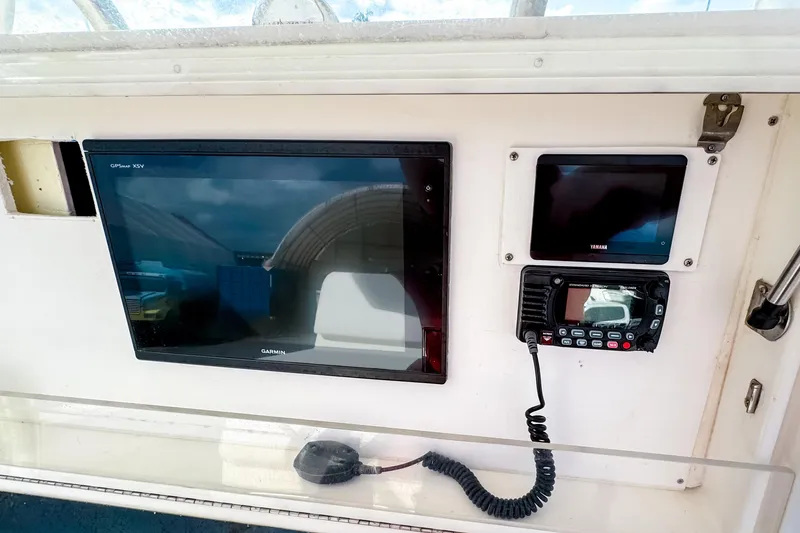 Slide: The Image of 2004 SeaVee 340i Cuddy dashboard with Garmin GPS and Yamaha display. - 12