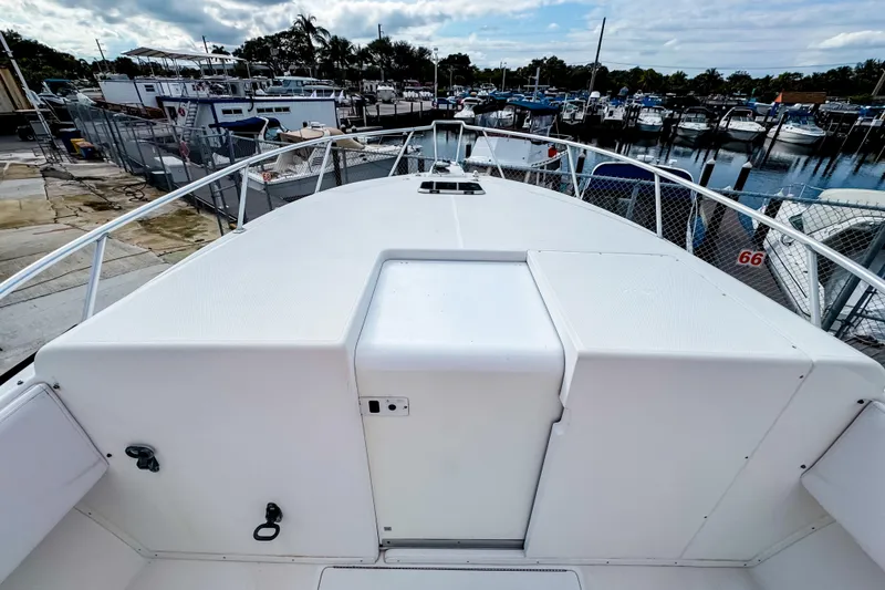 Slide: The Image of 2004 SeaVee 340i Cuddy boat deck at marina, surrounded by other boats. - 17