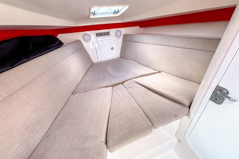 Slide: The Image of 2004 SeaVee 340i Cuddy cabin interior with beige cushions and red accents. - 18