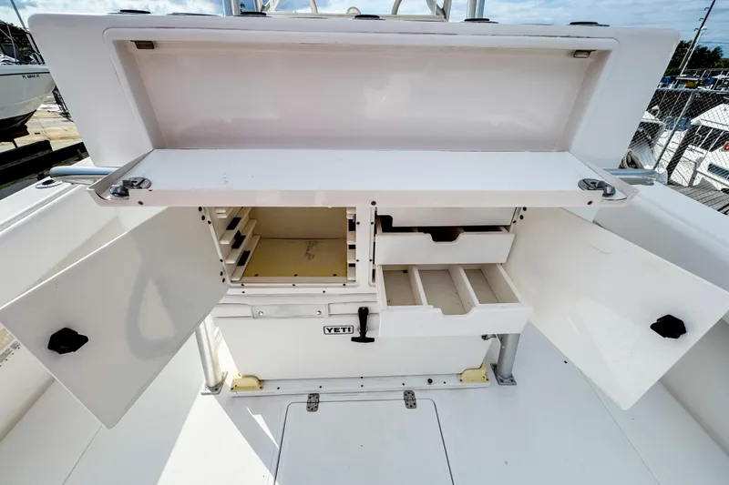 Slide: The Image of 2004 SeaVee 340i Cuddy boat storage compartments with open doors and drawers. - 7