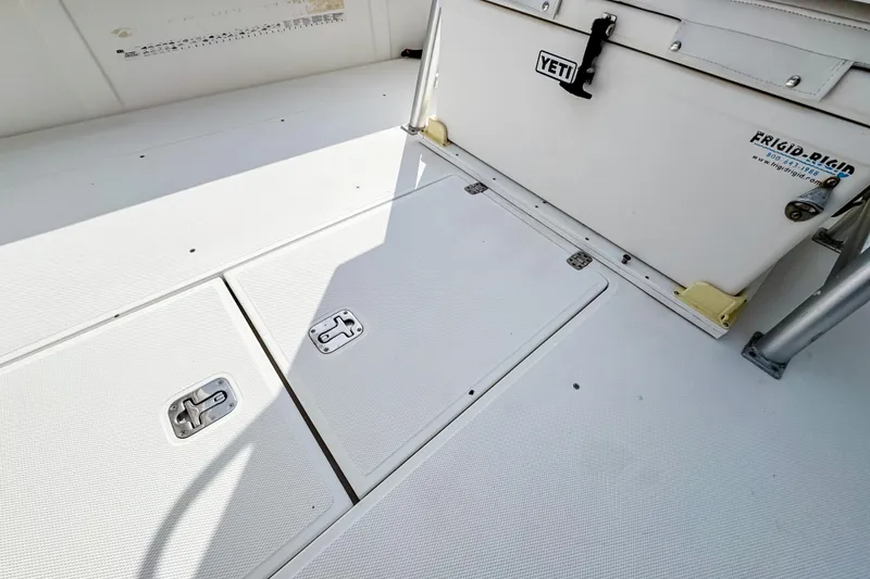 Slide: The Image of 2004 SeaVee 340i Cuddy deck with storage hatches and Yeti cooler. - 8