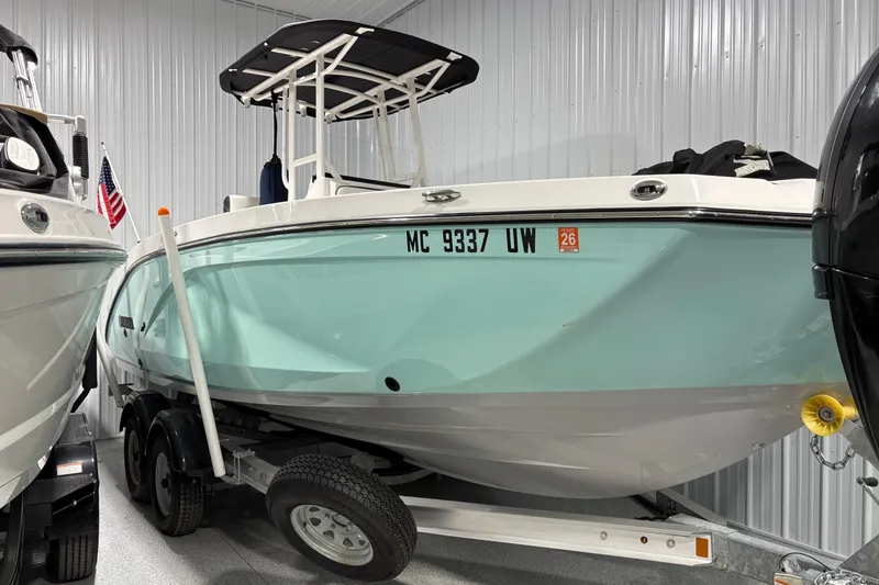 The Image of 2023 Yamaha Boats 222 FSH Sport in storage, featuring sleek design and modern amenities. - 0