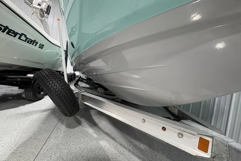 Slide: The Image of 2023 Yamaha Boats 222 FSH Sport in storage, side view with logo visible. - 11