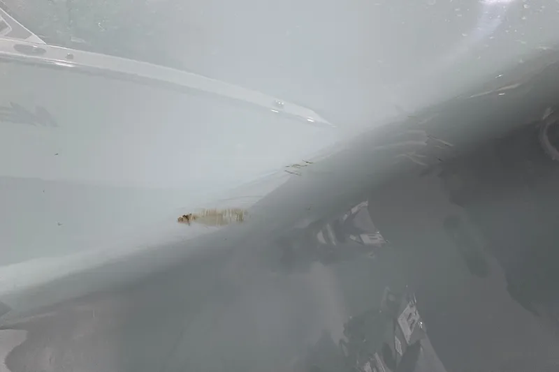 Slide: The Image of 2023 Yamaha Boats 222 FSH Sport on trailer, close-up of hull and wheel. - 19