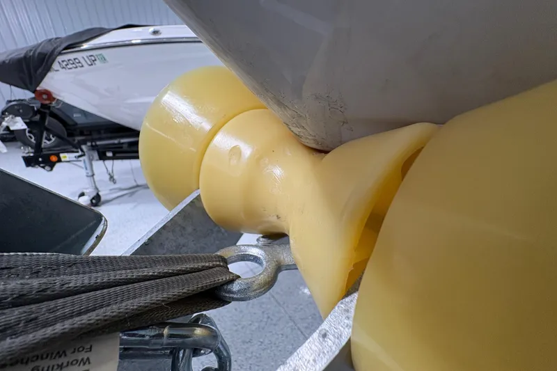 Slide: The Image of Trailer hitch of 2023 Yamaha Boats 222 FSH Sport in a garage setting. - 23